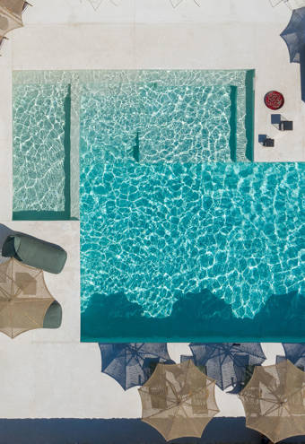 Koukoumi Vegan Hotel pool and sunbeds and umbrellas